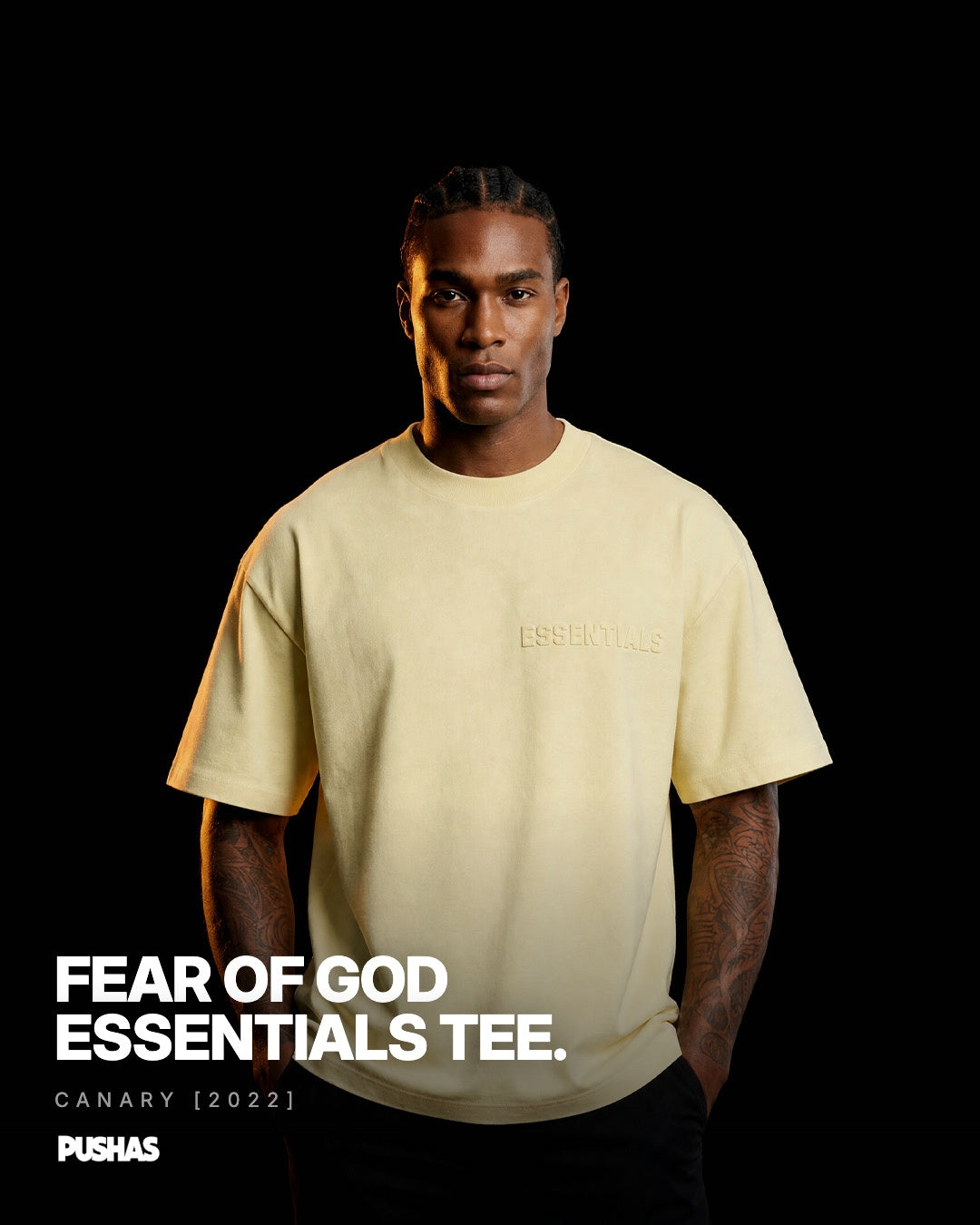 Fear of God ESSENTIALS T-Shirt 'Canary' FW22 pale yellow oversized tee on model, black background PUSHAS studio shot